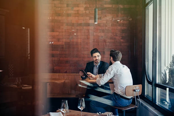 two Businessmen talking in restaurant