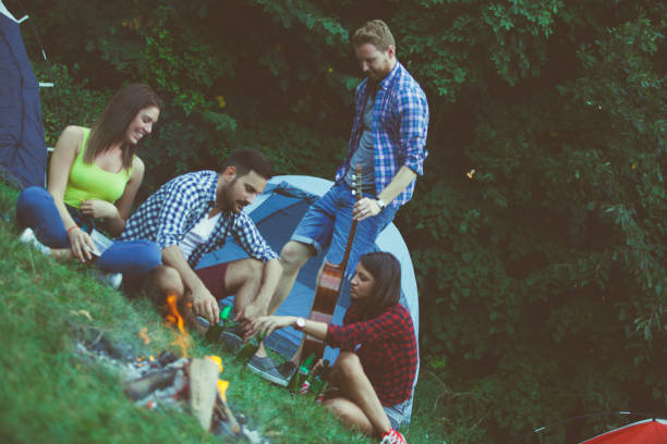 istock Friends chilling out on camping next to fireplace 686103236