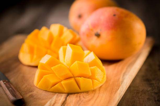 Mango fruit and mango slices stock photo
