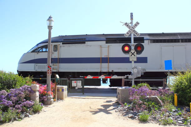 Barstow, California, United States - August 31, 2023:  Old train wagon of the Arizona & California Railroad and the railroad station of Barstow in the background.