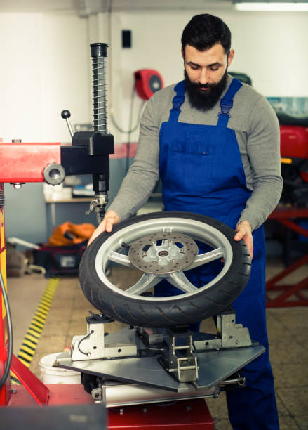 istock Expert inspects a wheel for a motorcycle 686114688