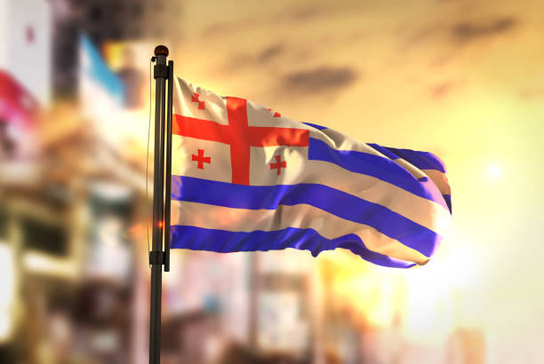istock Adjara Flag Against City Blurred Background At Sunrise Backlight 686124174