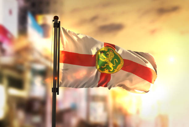 istock Alderney Flag Against City Blurred Background At Sunrise Backlight 686124216