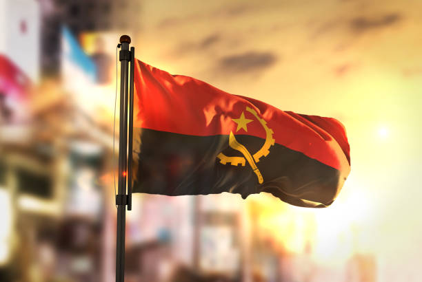 istock Angola Flag Against City Blurred Background At Sunrise Backlight 686124268