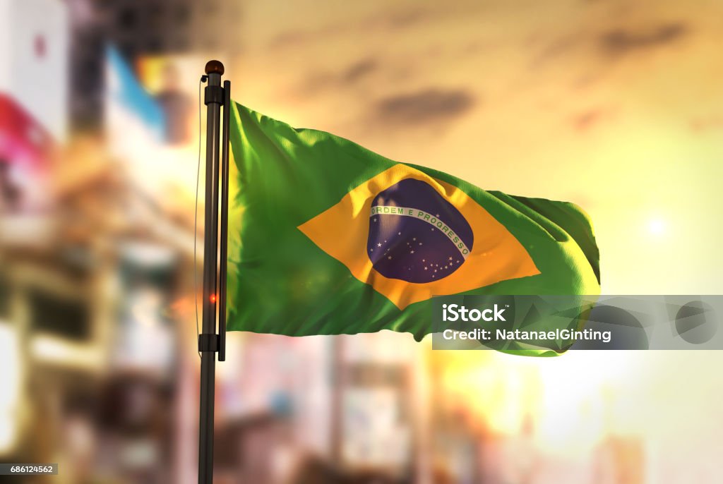 Brazil Flag Against City Blurred Background At Sunrise Backlight Brazil Stock Photo