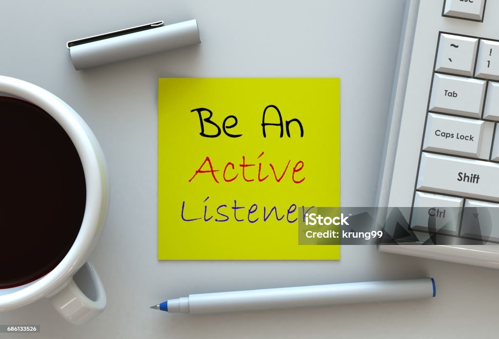 Be An Active Listener, message on note paper, computer and coffee on table Listening Stock Photo