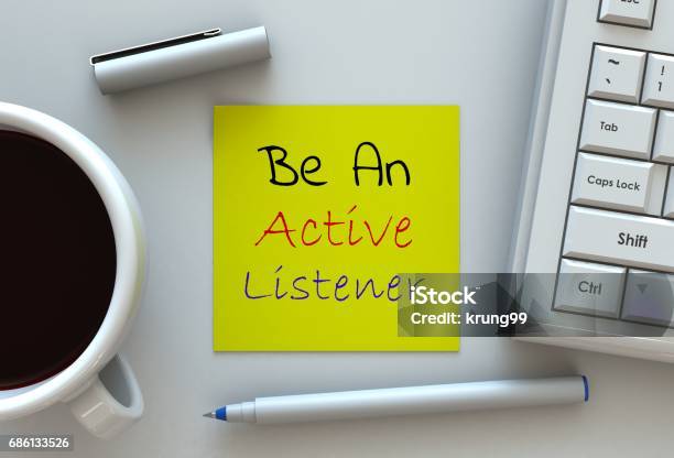 Be An Active Listener Message On Note Paper Computer And Coffee On Table Stock Photo - Download Image Now