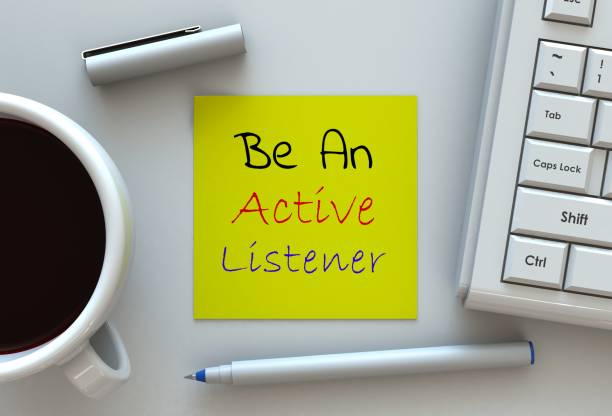 be an active listener, message on note paper, computer and coffee on table - garment emotional stress equipment household equipment imagens e fotografias de stock