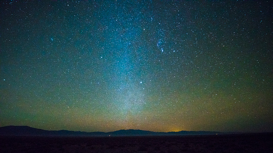 The starry sky with the Milky Way over the remote mountains at sunset in Nevada, USA