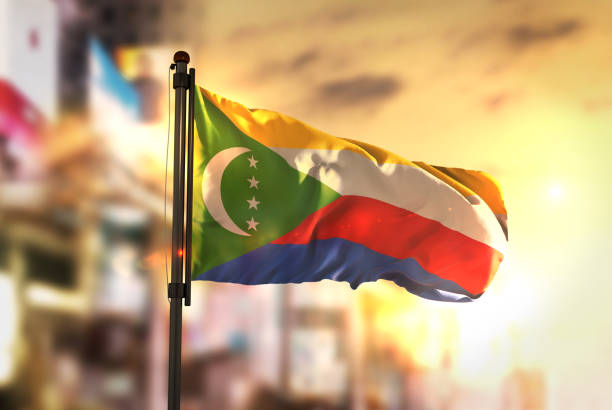 istock Comoros Flag Against City Blurred Background At Sunrise Backlight 686136918