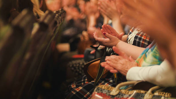 istock Women applaud at a concert 686140128