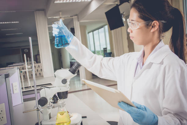 istock Young scientist with flask of sample substance and tablet computer in hand 686149096