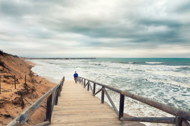istock man walking in stormy day. See swell 686160370