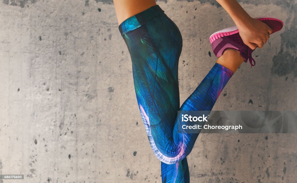 athletes foot close-up Fitness athletes foot close-up. Healthy lifestyle and sport concepts. Woman in fashionable sportswear is doing exercise. Leggings Stock Photo