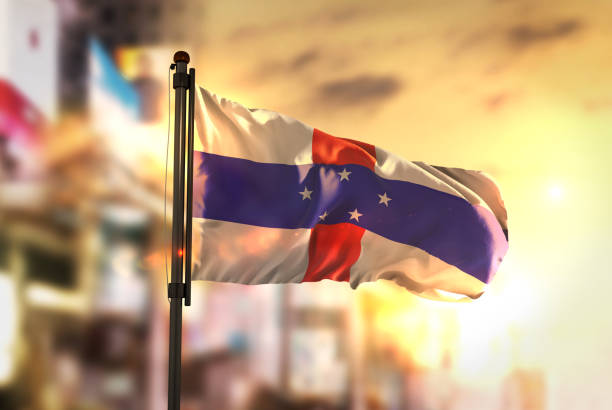 istock Netherlands Antilles Flag Against City Blurred Background At Sunrise Backlight 686178354