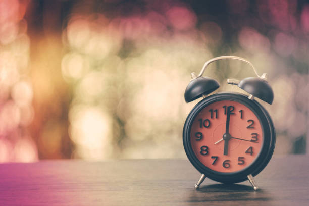 istock Black Vintage clock with red watch at six o'clock on bokeh background 686181922