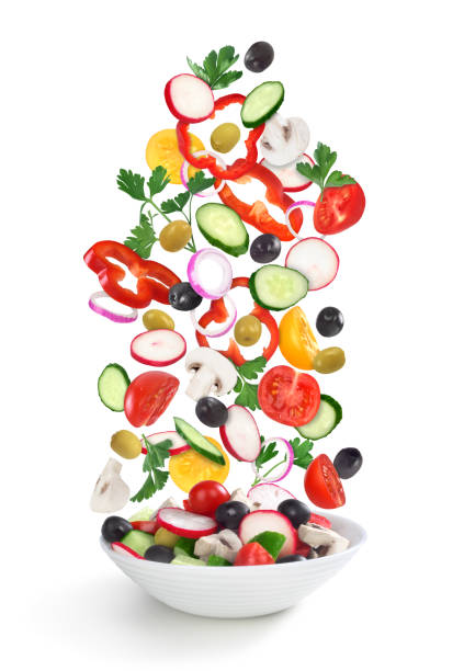istock flying salad in plate isolated on white 686184520