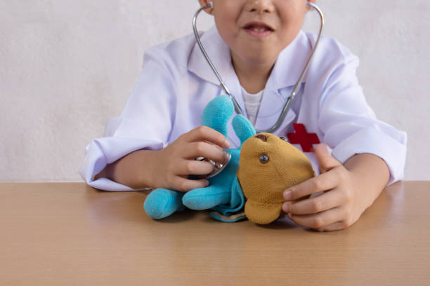 istock Asian boy playing as a doctor care bear doll 686190834