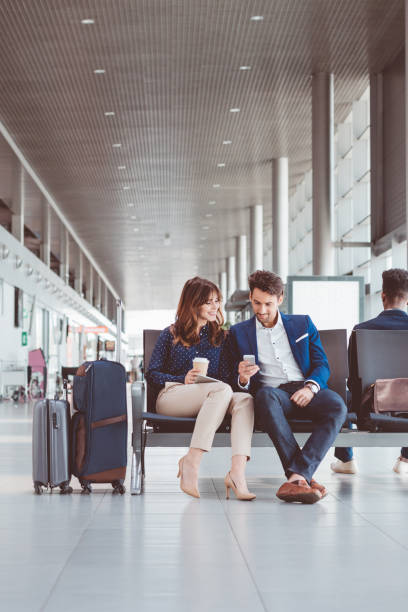 istock Young couple using mobile phone at the airport 686194794