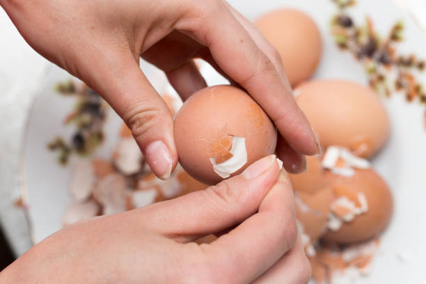 istock The girl is cleaning the egg with her hands 686194892