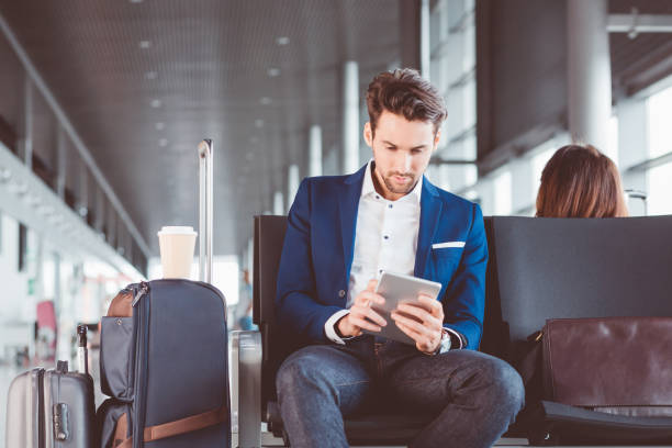 istock Businessman using a digital tablet in airport waiting area 686195322