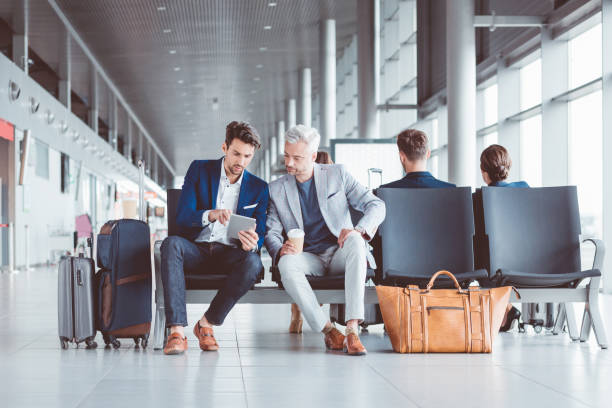 istock Business people using digital tablet at airport lounge 686197388
