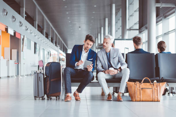 istock Two businessmen using digital tablet at airport 686197774