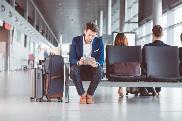 istock Young businessman using a digital tablet in airport waiting area 686198004