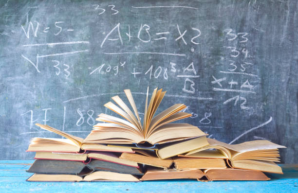 open books in front of a blackboard