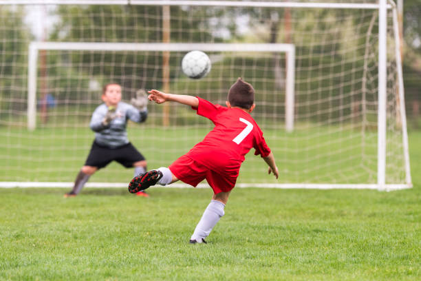 Kids soccer football - young children players match on soccer field stock photo