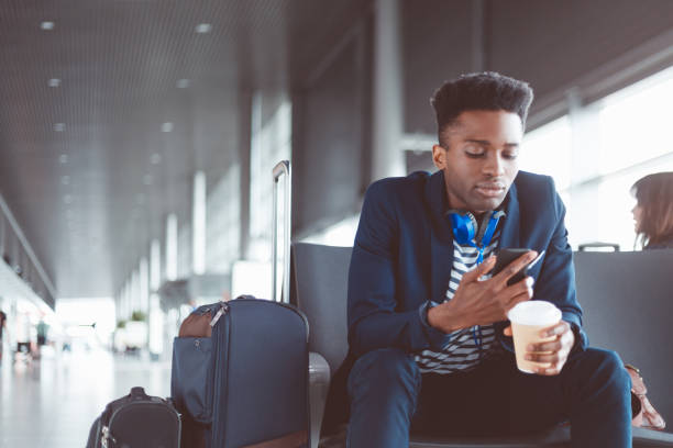 istock African businessman using cell phone at airport 686198752