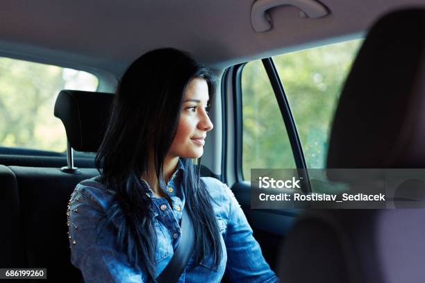 Woman In A Car Looking Out The Window Stock Photo - Download Image Now - Car, Passenger, Back Seat