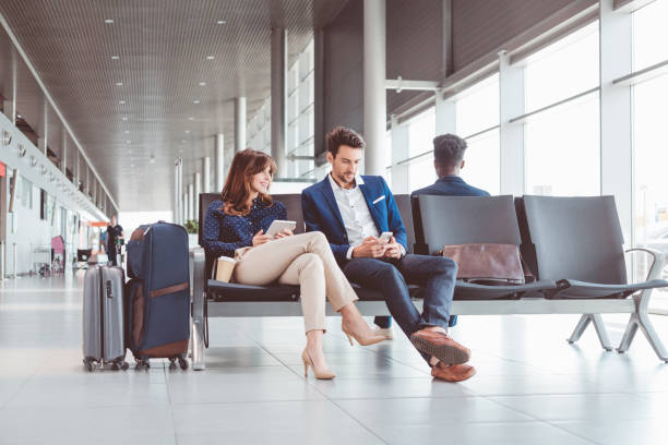 istock Business people waiting for flight at airport lounge 686199680