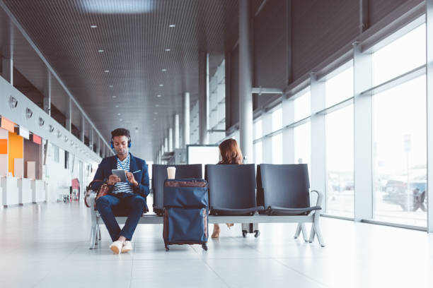 istock Young african man using digital tablet at airport lounge 686201840