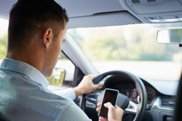 istock Man in the car with mobile phone 686202094