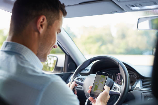 istock Man in the car and holding black mobile 686202102