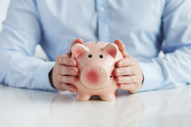 istock Man with piggy bank 686202174