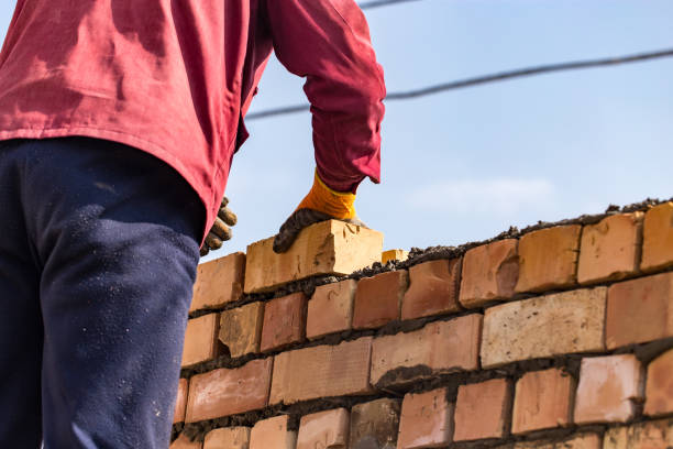 istock Worker builds a brick wall in the house 686205680