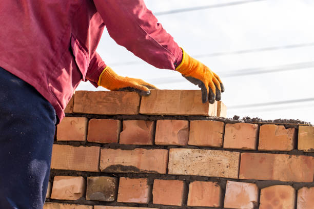 istock Worker builds a brick wall in the house 686206252