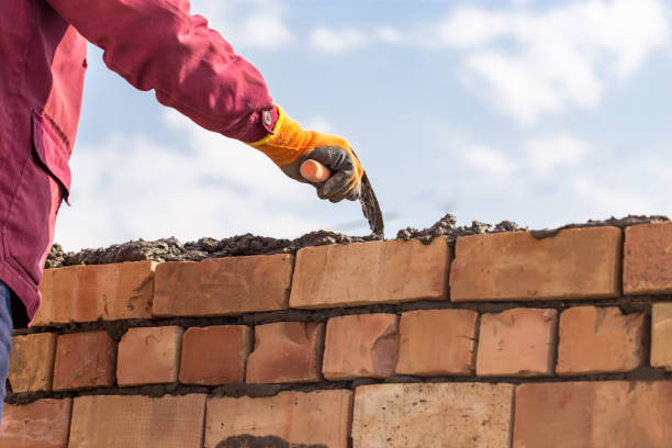 istock Worker builds a brick wall in the house 686207324