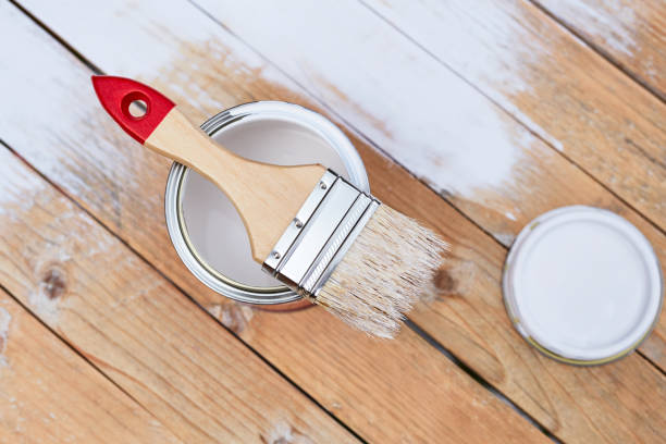 istock Paintbrush with can on wooden table 686211698