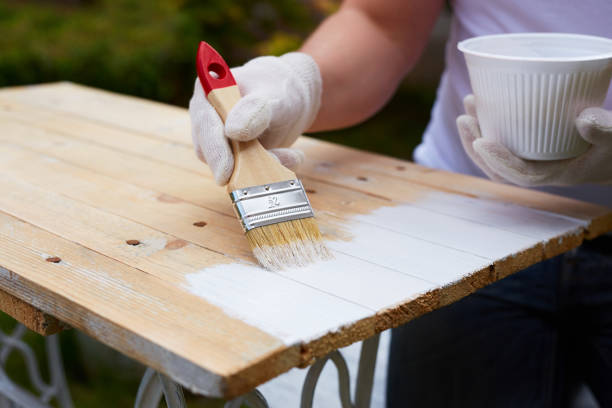 istock Man painting on a wooden table 686211902