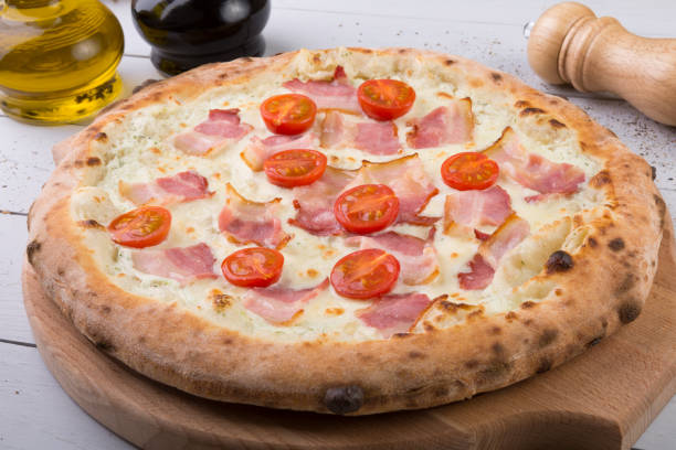 istock Whole baked pizza on wooden board 686212586