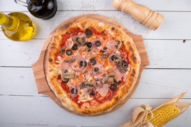 istock Whole baked pizza on wooden board 686212606