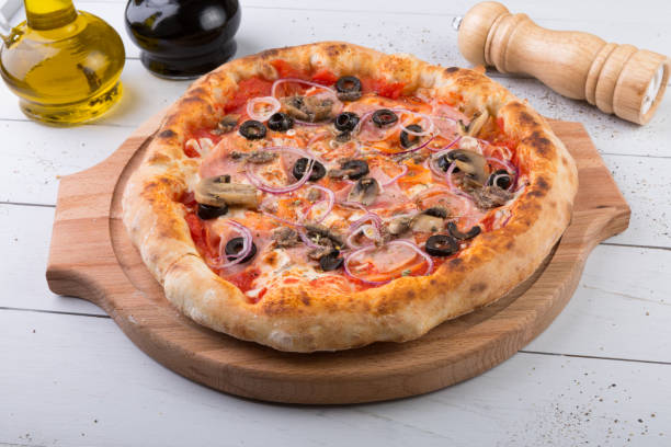 istock Whole baked pizza on wooden board 686212616