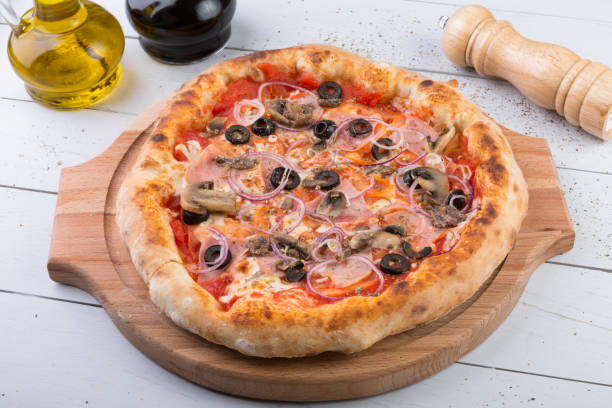 istock Whole baked pizza on wooden board 686212618