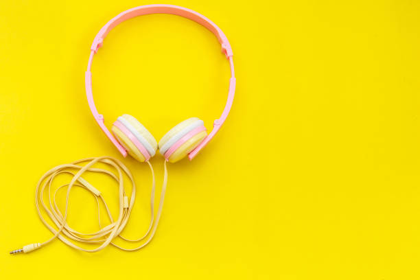 istock Top view new pink music headphone on yellow backgrounddesign 686216172