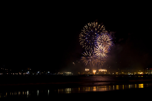 View from the beach of fireworks from San Sebastian city celebration (Guipuzcoa, Spain).
