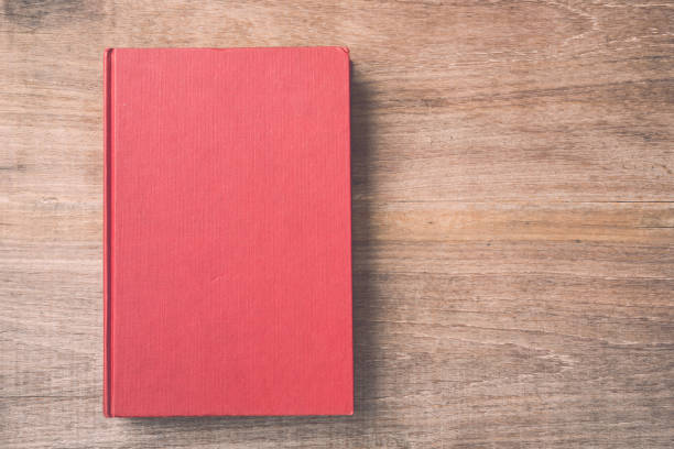 istock Old book on wooden plank background 686225612