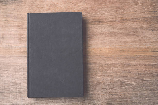istock Old book on wooden plank background 686225848